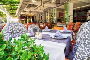 a table with plates and napkins on it in a restaurant at Sunway Apart Hotel in Alanya