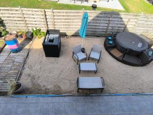an overhead view of a patio with chairs and an umbrella at Smiley in Blankenberge +1 photo