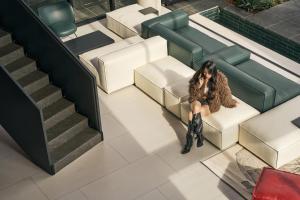 a woman sitting on a chair in a lobby at Mevan Hotel Dalat in Da Lat +99 photos