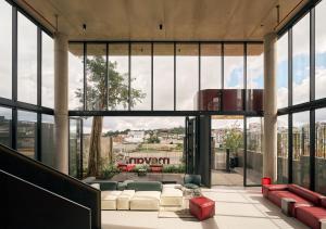 a living room with a large glass wall at Mevan Hotel Dalat in Da Lat