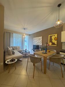 a living room with a couch and a table at Blue Paradise - Gjiri i Lalezit in Lalzit Bay