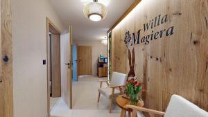 a hallway with a wall with a sign that reads milka micropolitan at Willa Magiera - widok na Trzy Korony in Sromowce Niżne