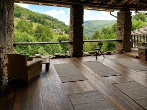 a living room with a view of a mountain at Stone Oven House in Rorá