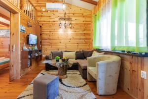 a living room with a couch and a table at Bamboo River House in Ulcinj