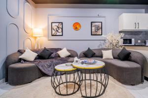a living room with a couch and a table at Modern executive stay in Lahore Long stay ready in Lahore