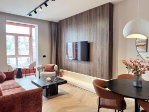 a living room with a couch and a table at Old Town Luxe Loft in Iaşi