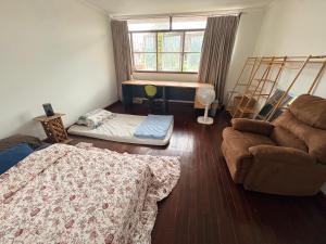 a living room with a couch and a bed and a window at Southeast Asia Activist House in Bangkok +29 photos