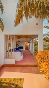 a hallway of a house with a palm tree at VILLA Fleurie in Mafia