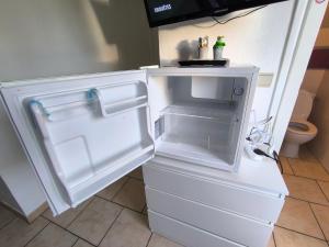 an empty refrigerator with its door open in a kitchen at Villa vague bleue Blankenberge in Blankenberge