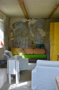a living room with a bed and a couch at Modern seaside barn in Borrby