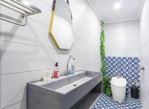 a bathroom with a sink and a toilet at Flamenco@Colwyn in Sheffield Beach