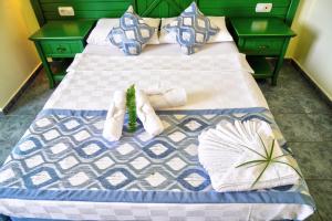 a bed with two towels and a plant on it at Sunway Apart Hotel in Alanya +48 photos