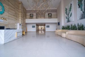 a lobby of a building with couches and plants at Modern executive stay in Lahore Long stay ready in Lahore