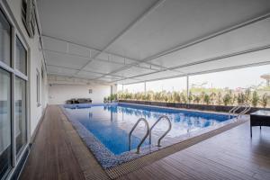 a swimming pool with two metal swans in a building at Modern executive stay in Lahore Long stay ready in Lahore