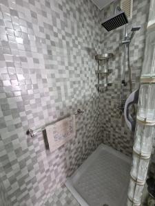 a bathroom with a shower with a tiled wall at Tranquilo y céntrico en Chipiona in Chipiona +20 photos