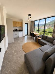 a living room with a couch and a table at Mirşah Suit in Dalaman +34 photos