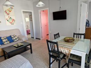 a living room with a table and a couch at Tranquilo y céntrico en Chipiona in Chipiona