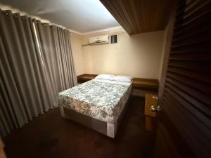 a small bedroom with a bed in a room at Sunrise and sunsets lodge previously known as leopard lodge in Kariba +10 photos