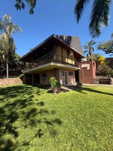 a house with a large lawn in front of it at Sunrise and sunsets lodge previously known as leopard lodge in Kariba