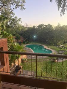a view of a swimming pool from a balcony at Sunrise and sunsets lodge previously known as leopard lodge in Kariba