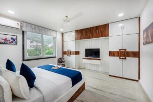 a bedroom with a large bed and a television at Sunset view Villa 966o9o1oo6 Luxury 5BHK Villa with pool in Nathdwara 2km from temple only By SK in Nāthdwāra