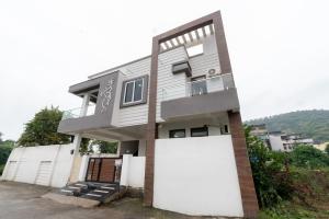 a house with a large white garage at Sunset view Villa 966o9o1oo6 Luxury 5BHK Villa with pool in Nathdwara 2km from temple only By SK in Nāthdwāra