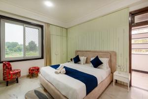 a bedroom with a large bed and a window at Sunset view Villa 966o9o1oo6 Luxury 5BHK Villa with pool in Nathdwara 2km from temple only By SK in Nāthdwāra +60 photos