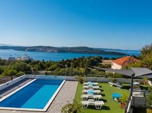 a villa with a swimming pool and a view at Villa Confido - Luxury 3BR Apartment with Private Pool near Trogir in Donji Seget