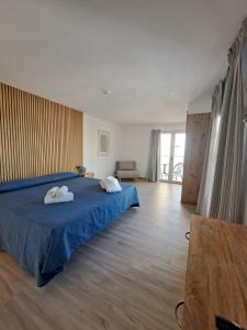 a bedroom with a bed with two towels on it at Aparthotel ALMARIS in Es Pujols