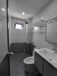 a bathroom with a white toilet and a sink at ZENITH STAY by Lan's in Danang +37 photos