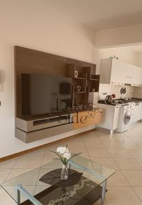a kitchen with a vase of flowers on a glass table at Bijou - Lake side apartments in Sandra