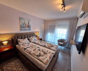 a bedroom with a large bed in a room at Villa Rosa - Luxury Apartments in Vrsi