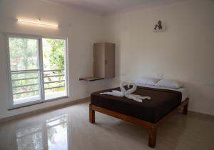 a bedroom with a bed with a white towel on it at Rock Retreat in Kanakapura +68 photos