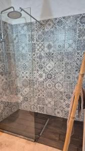 a shower with a glass door and a tile wall at Papoila in Grândola +47 photos