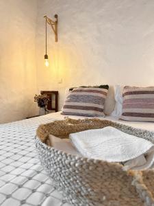 a bedroom with a bed with a basket on it at Papoila in Grândola