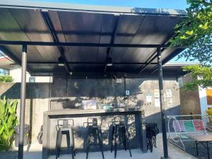a patio umbrella with two stools under it at Cina Home in Chiang Mai