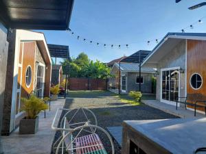 a patio with two chairs and some houses at Cina Home in Chiang Mai +27 photos