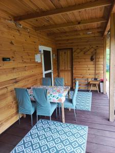 a patio with a table and chairs on a deck at Przystanek Natura in Radzie