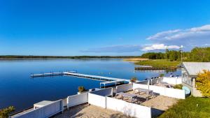 an image of a dock on a lake at Surf Domki Habenda z sauną ogrodową in Sarbsk