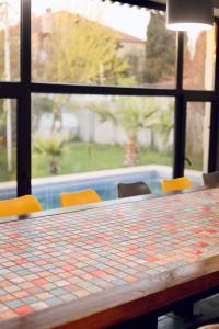 a table with chairs and a view of a pool at Villa Verde w Warm Pool, BBQ, Concierge in Baku
