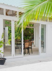 a view of a patio with chairs and a table at Arena Blanca in Rasdhoo