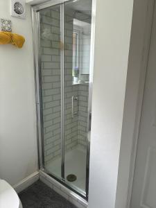 a shower with a glass door in a bathroom at The Hideaway-Sharples-Bolton in Bolton +35 photos