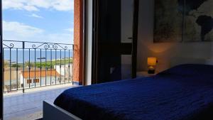 a bedroom with a bed and a view of the ocean at Hotel Bellavista S'Archittu in S'archittu Cuglieri