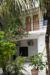 a building with a balcony with flowers on it at Arena Blanca in Rasdhoo +9 photos