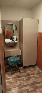 a room with a bed with a mirror and a stool at Hunza Embassy Hotel by Zeez in Karimabad Hunza