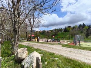 a playground in a park with rocks in the grass at Le Nid de Formiguères in Formiguères