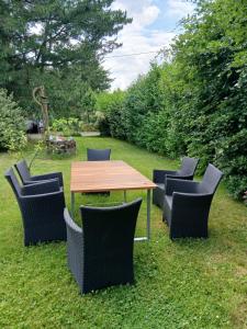 a wooden table and chairs in the grass at Eva Domizil in Laudesfeld