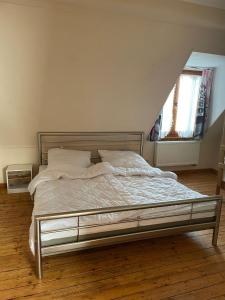a large bed in a bedroom with a window at Eva Domizil in Laudesfeld