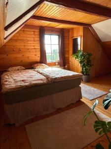 a bedroom with a bed in a log cabin at Farm Stay Between Forests and Meadows in Ulricehamn