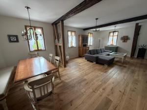 a living room with a table and a couch at Wohnen im Denkmal in Weilrod